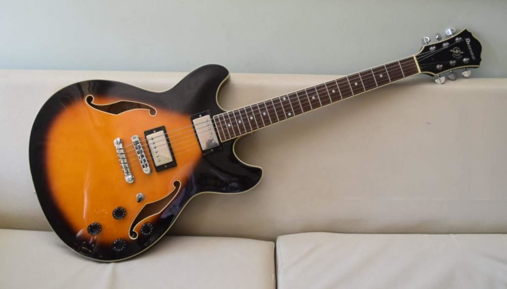 Image of semi-hollow sunburst guitar.