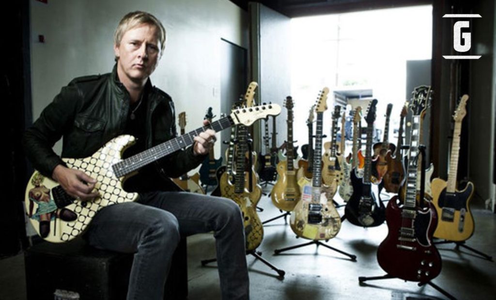 The guitarist with his collection of guitars.