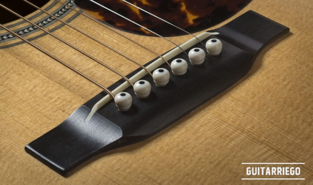 Acoustic guitar ebony bridge.